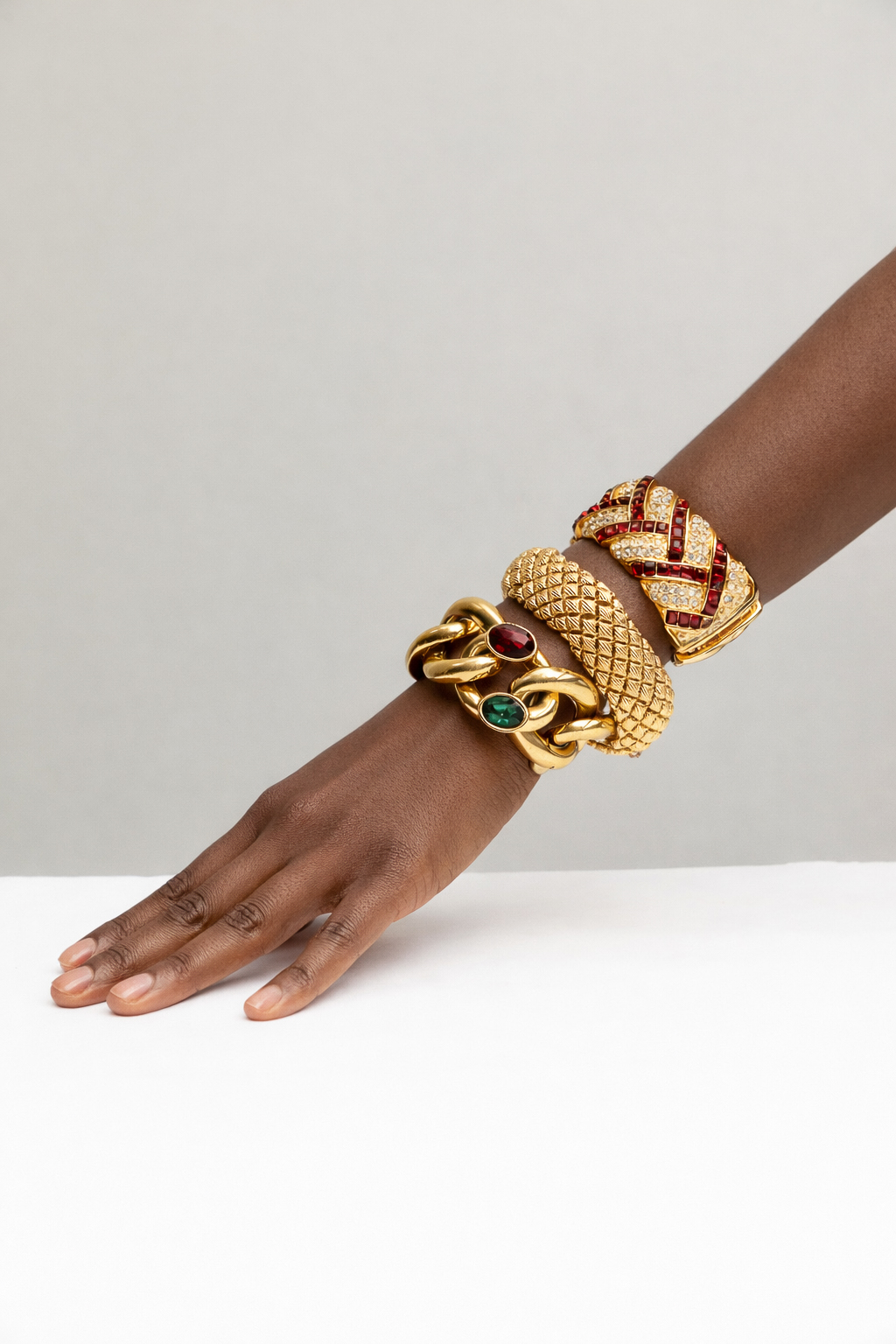Stacked vintage bracelets shown on woman's arm